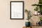 Mock up poster on the beige wall in stylish room with plants.