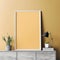 Mock up poster frame on cabinet over yellow wall. Background with copy space. Interior design of modern living room. Created with