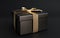 Mock-up poster, very expensive brushed black gift box with gold bow on dark background