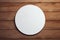 Mock-up of a round white sticker on a wooden background