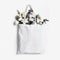 Mock-up scene of blank shopping canvas tote bag with pink tulips, daffodils flowers and eucalyptus isolated on white