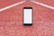 Mock Up smartphone at the stadium for running. Concept on the topic of sport.