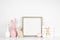 Mock up square wood frame with shabby chic Easter decor on a white shelf