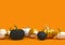 Mock up trendy autumn sale border. Golden and black pumpkins in row on orange background.