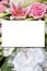 Mock-up wedding pastel pink flower rose bouquet and bride groom rings with white sheet paper empty space for marriage text mock up