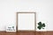 Mock up wood frame with St Patricks Day shabby chic decor on a wood shelf against a white wall