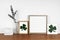 Mock up wood frame with St Patricks Day shabby chic decor on a wood shelf against a white wall