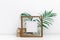 Mock up wooden frame with green tropical leaves. Nordic decorations,