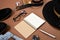 Mock up workspace with hat, clock, pen, perfume, jeans, purse, belt, footwear, notepad and eyeglasses on brown background. Concept