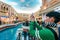 The mock Venetian canal in the Venetian Macau Resort Hotel. Asian tourist shooting selfie. Macao, Russia