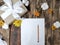 Mockup autumn flatlay composition with gift box, flowers, empty card on wooden table.