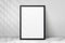 Mockup black frame photo on wall. Mock up artwork picture framed. Vertical boarder with shadow. Empty board photoframe a4. Modern