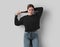 Mockup of a black sweatshirt on a posing girl, stylish clothes for design, print, pattern, advertising, front view