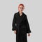 Mockup of a black terry bathrobe with a belt on a red-haired girl, a winter robe for design, branding, front view