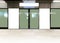 Mockup of blank poster advertising space in generic train station; OOH mock up. Straight front view of MRT platform, without