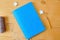Mockup blue natebook with colorful pencils on wooden table. Flat lay, top view photo mock up