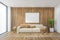 Mockup canvas frame over white sofa in wooden living room with big window