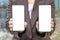 Mockup cellphone. businesswoman in a suit shows two phones. Blank screen mockup