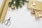 Mockup Christmas tree decor top view Packing paper and gold gift ribbon and scissors, flatlay on a white wooden