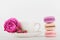 Mockup of coffee cup with rose flower and stack of macaroon on white table with empty space for text and design your blogging.