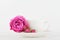 Mockup of coffee cup and rose flower on white desk with clean space for text and design your blogging.