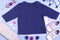 Mockup for design and placement of logos, advertising. Blue children`s raglan, polo, blouse top view, mockup on a blue background