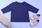 Mockup for design and placement of logos, advertising. Blue children`s raglan, polo, blouse top view, mockup on a blue background