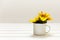 Mockup with enamel cup and sunflowers. Empty white cup with space for text, print or pattern. White background. Creative concept