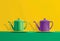 Mockup enamelware on yellow, purple and green background. Ad posters. Minimalistic color enamel objects.