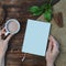 Mockup Flat lay composition with book, hand , cup of coffee on wooden table eco concept Copyspace
