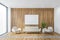 Mockup frame above white armchairs with sofa in wooden hall, wooden wall and rug