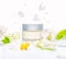 mockup of hand, facial or body cream with spring flowers, concept announcement sale or promotion new product