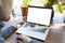 Mockup image, laptop computer with white blank screen close up and back view of businessman in casual clothes.