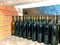 Mockup image of red wine bottles on stone shelf at local winery - homemade wine or various alcohol fruit drinks in local