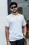 Mockup image of a young bearded man doing a pose while wearing white blank shirt