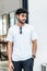 Mockup image of a young bearded man doing a pose while wearing white blank shirt