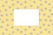 Mockup of invitation or congratulation on the background of a pattern of daisies. Top view, copy space