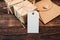 Mockup kraft gift boxes with tag on wooden background