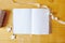 Mockup opened blank notepad with colorful pencils on wooden table. Flat lay, top view photo mock up