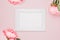 Mockup photo frame on a pink background with flowers. Delicate elegant background with pink peonies, peony buds. Flat lay, top