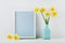 Mockup of picture frame decorated daffodil flowers in vase with clean space for text your blogging and greeting for mother day.