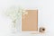 Mockup of picture frame decorated gypsophila flowers in vase on white working table with clean space for text and design your blog