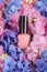 Mockup of pink varnish on the bed of hortensia. Fashion beauty c