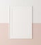 Mockup poster frame close up on wall painted white and pastel pink color