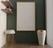 Mockup of a rectangular painting, a poster in a gold frame on a green wall in an interior