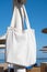 Mockup shopper handbag hanging on the beach