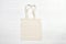 Mockup shopper handbag on wood background. Top view copy space shopping eco reusable bag. Grocery accessories. Template blank top