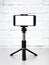 Mockup with smartphone on a tripod with empty screen