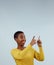 Mockup, smile and black woman with hand pointing up in studio for presentation on grey background. News, announcement