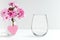 Mockup - stemless wine glass, next to blossom in a vase